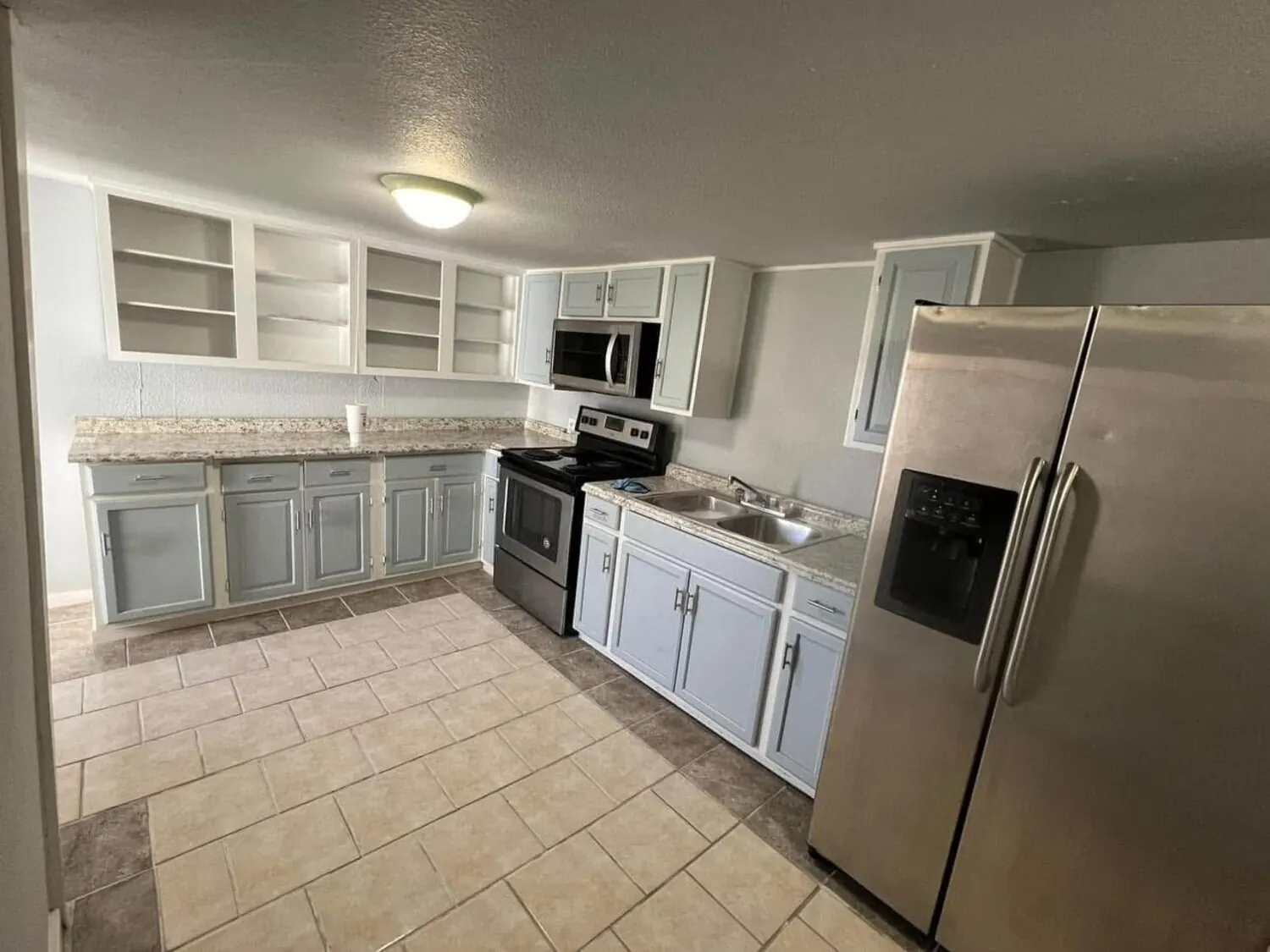 Kitchen after remodel with counters and appliances