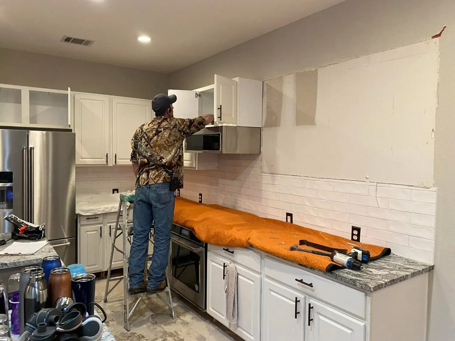 Kitchen before remodel with wall cabinet work underway