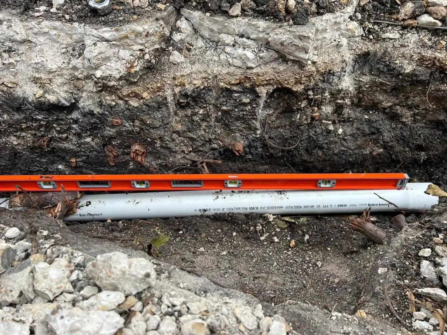 Replacement sewer pipe set in trench